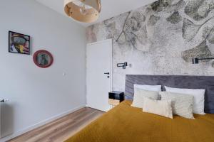 a bedroom with a large bed with white pillows at Targowa 10 Modern 2BR Apt in Warsaw