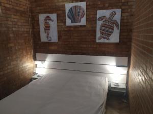 a bedroom with a bed with a brick wall at B & B Torre Saracena in Mattinata