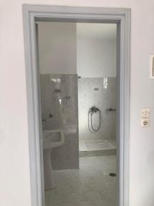 a bathroom with a shower and a toilet and a sink at Port view Studios in Vathi