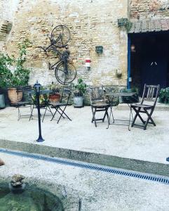 un patio con mesa y sillas junto a un edificio en au 33 chambres d'hôtes en Saint-Omer