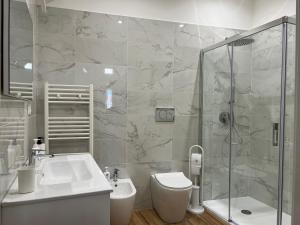 ein Bad mit einem WC, einem Waschbecken und einer Dusche in der Unterkunft Genuardi’s apartment in Acireale