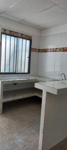 an empty room with a table and a window at Apartamentos Mage in Cerro el Bita