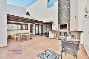 a large living room with a table and a fireplace at Vivienda Vacacional Casa Erizo adults only in Nazaret