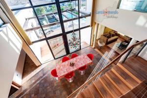an overhead view of a dining room table and red chairs at Vivienda Vacacional Casa Erizo adults only in Nazaret