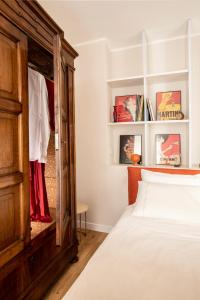a bedroom with a bed and a wooden cabinet at una stanza in carmine in Brescia