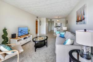 a living room with a couch and a tv at Bayshore Yacht & Tennis 314 in Clearwater Beach