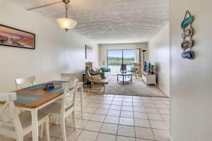 a dining room and living room with a table and chairs at Bayshore Yacht & Tennis 314 in Clearwater Beach