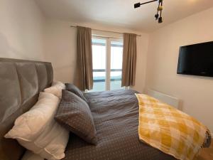 a bedroom with a bed with pillows and a television at Zen Apartments Jahorina - Snježna Dolina Resort in Jahorina