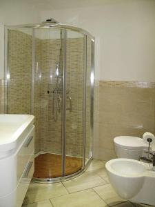 a bathroom with a shower and a toilet and a sink at Casa Simone in Omegna