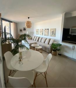 a living room with a white table and chairs at Villa Bruno con vistas al mar, primera línea de playa in Cotillo