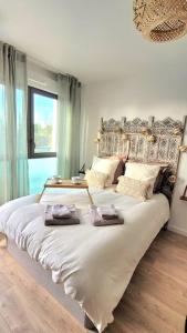 um quarto com uma cama grande com duas toalhas em Paisible Provence avec terrasse sur vue piscine em Éguilles