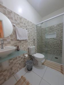 a bathroom with a toilet and a sink and a shower at Suíte Próxima a Praias! in São Luís