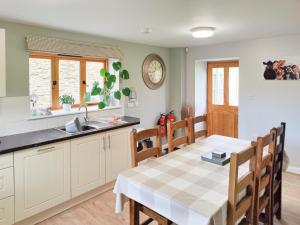 a kitchen and dining room with a table and chairs at The Buttery - RFFO in Fownhope
