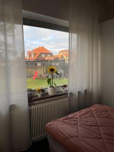 a bedroom with a window with a flower pot on a window sill at Brabo2 in Landskrona