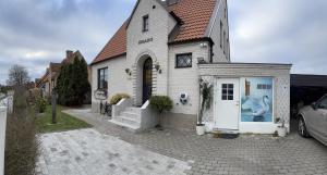 a white house with a white door and a driveway at Brabo2 in Landskrona