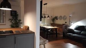 a kitchen and a living room with a couch and a table at Apartamento Aguilera in Gandía