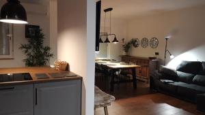 a kitchen and a living room with a couch and a table at Apartamento Aguilera in Gandía +28 photos