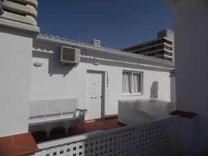 einen Balkon mit einer Bank auf einem Gebäude in der Unterkunft Apartamentos San Miguel in Torremolinos