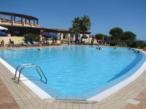 a large pool with blue water in a resort at Villa Elma in Villaputzu +28 photos