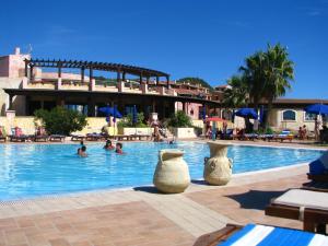 a swimming pool with three vases sitting in the water at Villa Elma in Villaputzu