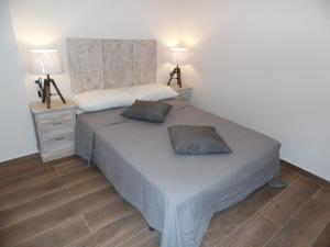 Ein Bett oder Betten in einem Zimmer der Unterkunft Apartamentos San Miguel