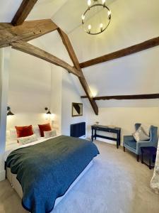 a bedroom with a large bed and a table at Slowley Farm Cottage in Luxborough