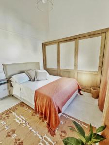 a bedroom with a large bed and a rug at Casa Maddy Anacapri in Anacapri