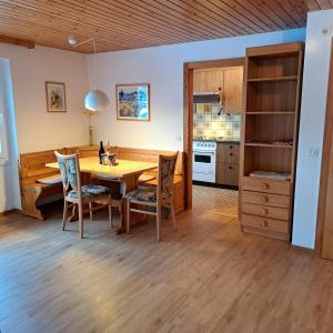 a kitchen and dining room with a table and chairs at Chalet Waldrand in Inden