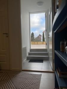 a hallway with an open door with a window at BRABO in Landskrona