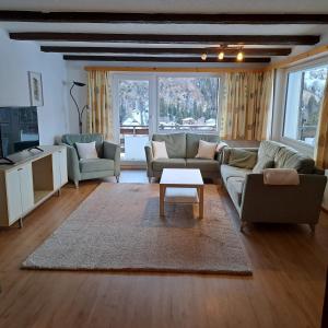 a living room with two couches and a coffee table at Chalet Waldrand in Inden