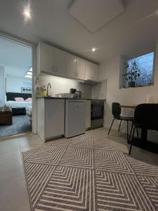 a kitchen with a counter and a table in a room at BRABO in Landskrona