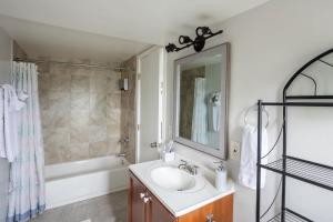 a bathroom with a sink and a mirror and a tub at Special Studio in Center of San Diego in San Diego