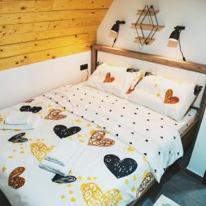 a bedroom with a bed with hearts on it at Vila Nadežda Divčibare in Divčibare