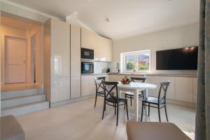 a kitchen with a table and chairs in a room at Apartvilla Pag in Pag