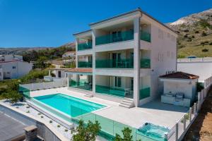 an aerial view of a house with a swimming pool at Apartvilla Pag in Pag