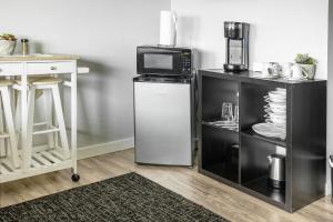 a kitchen with a microwave and a small refrigerator at COZY Studio in Downtown San Diego in San Diego