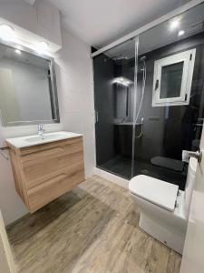 a bathroom with a toilet and a sink and a shower at Pollensa Beach Loft in Port de Pollensa