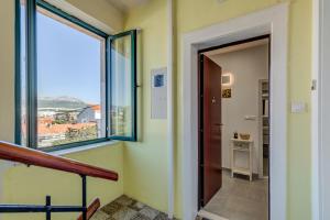 a hallway with a large window and a door at Split centar Aria apartment in Split