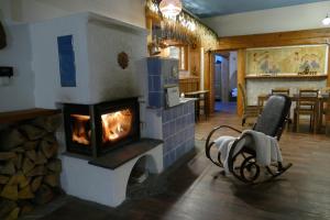 a fireplace in a living room with a stove at Chalupa Pohoda in Velké Karlovice