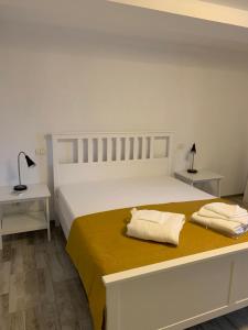 a bedroom with a bed with two pillows on it at Pensiunea Delta Drill in Sfântu Gheorghe