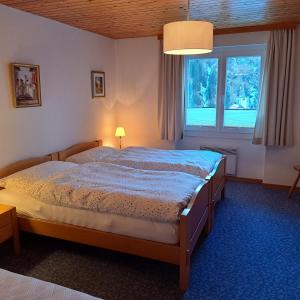 a bedroom with a bed and a large window at Chalet Waldrand in Inden