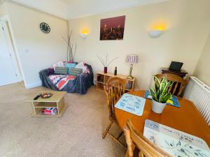 a living room with a table and a couch at 22B in Wellingborough