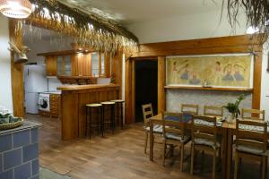 a kitchen and dining room with a table and chairs at Chalupa Pohoda in Velké Karlovice