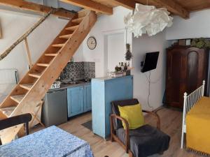a kitchen with a wooden staircase in a room at Apartman MiLu in Cres