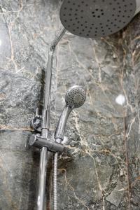 a shower head sitting on top of a rock at Сердце города 1комн ЖК Молодёжный in Almaty
