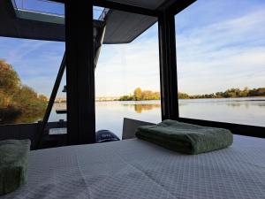 a bedroom with a bed and a view of a river at Casa barco Valada in Morgado