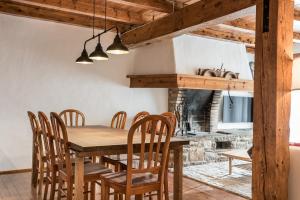 a dining room with a wooden table and chairs at Riu Nere - Pleta de Jus by Totiaran in Naut Aran