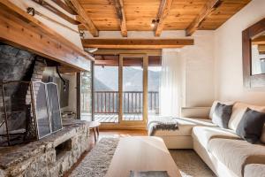 a living room with a couch and a fireplace at Manaud - Pleta de Jus by Totiaran in Baqueira-Beret