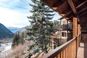 a balcony of a house with a tree on the side at Manaud - Pleta de Jus by Totiaran in Baqueira-Beret