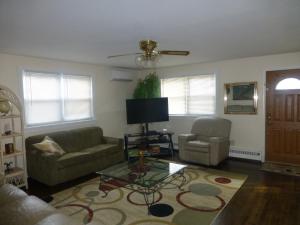 a living room with two couches and a tv at Red brick house in Chalfont